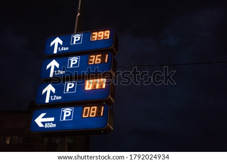 Electronic traffic sign directing vehicles towards their numbered spaces in a commercial parking lot