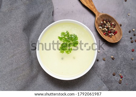 Beef broth green and spices on grey background. Horizontal frame.