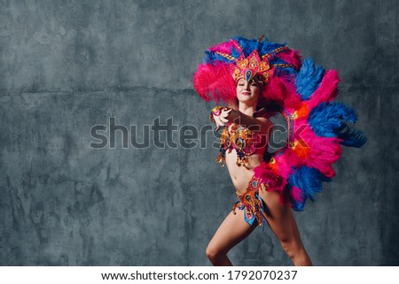 Woman in brazilian samba carnival costume with colorful feathers plumage. Royalty-Free Stock Photo #1792070237