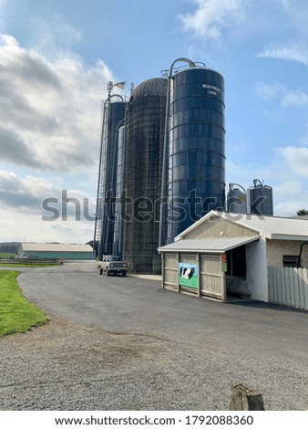 A picture of a farm with 4 silos.