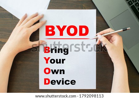 Bring your own device (byod) the girl writes on paper next to her laptop