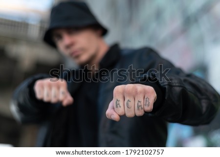 ACAB tattoo on the arm of a bully man