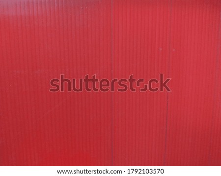 Red background picture with 2 pen marks.
