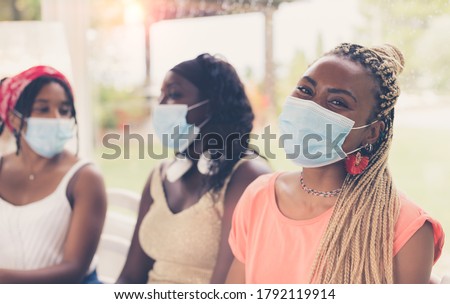 Close-up of three African American girls wearing surgical masks. Concept of new normal lifestyle. Royalty-Free Stock Photo #1792119914