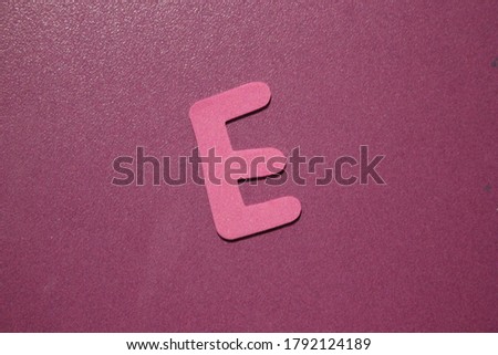 Letter E of English alphabet on pink background wall