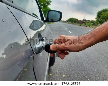 Picture of a person unlocking his car with key