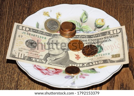 American dollars and cents are on a white plate