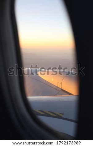 View from the window of the airplane at the sunrise.