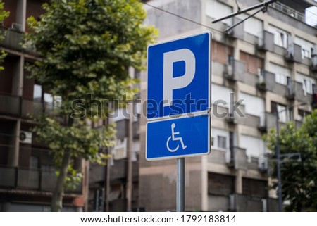 Metal traffic sign indicating a parking area reserved for disabled persons