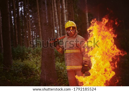 firefighter portrait on authentic fire location in forest