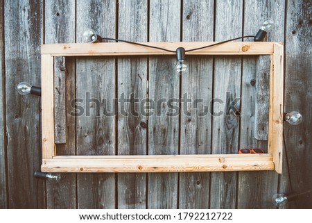 Wooden frame on wooden wall, vintage and warm edit