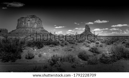 Black and White Photo of The sandstone formations of Merrick Butte and East Mitten Butte in the desert landscape of Monument Valley Navajo Tribal Park in southern Utah, United States