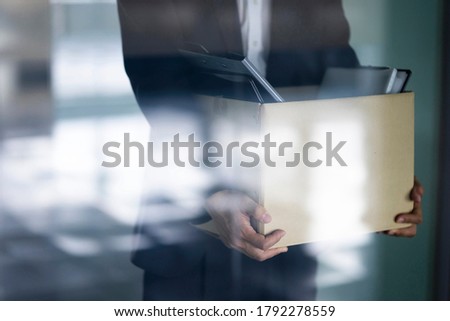 Fired businessman carrying box of personal items
 Royalty-Free Stock Photo #1792278559