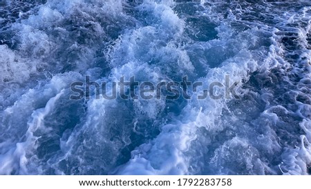 Seawater surface. White foam waves texture as a natural background. Royalty-Free Stock Photo #1792283758