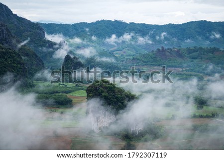 Landscape image of foggy greenery rainforest mountains and hills 