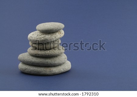 pebble stack on a blue background