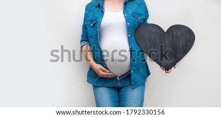 Pregnant woman holds empty template whiteboard