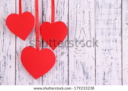 Paper hearts on wooden background