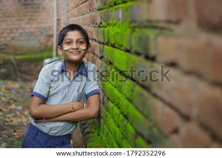 young indian child with indian flag on face