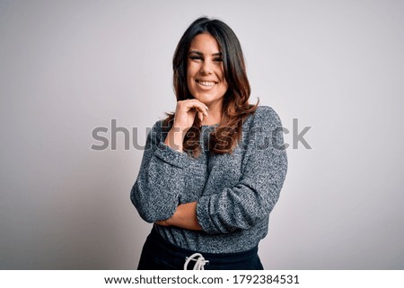 Young beautiful brunette woman smiling happy and confident. Standing with smile on face wearing casual sweater over isolated white background