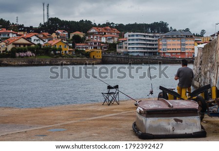 A mesmerizing view of the seascape with buildings on the background in Luanco, Asturias, Spain