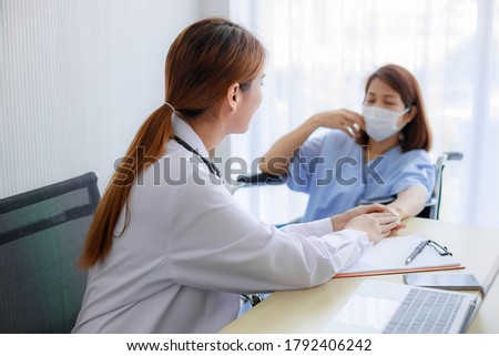 Friendly Asian female doctor's hands holding female patient's hand for encouragement and empathy. Medical psychology in encouraging and reducing the negative effects of sick people.