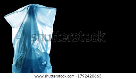 A man covered with a white shroud like a ghost shows horror isolated on black background with copy space, Halloween and horror, with clipping path
