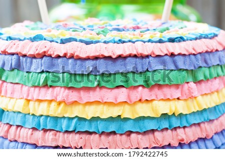 Close up of colourful rainbow party themed butter cream cake