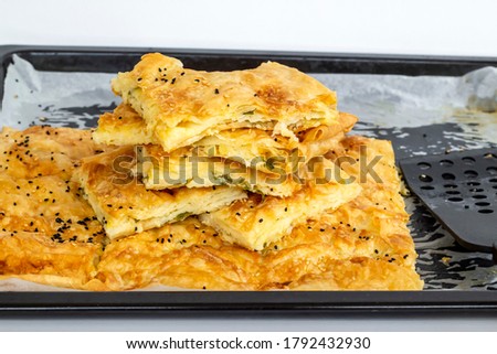 Traditional Turkish homemade tray pastry sliced in metal tray of oven