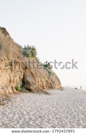 View of the mountain by the sea. Beach, rock side. Sunrise. Photo color, vertical.