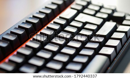 Black computer keyboard. Large keys. Sunlight.