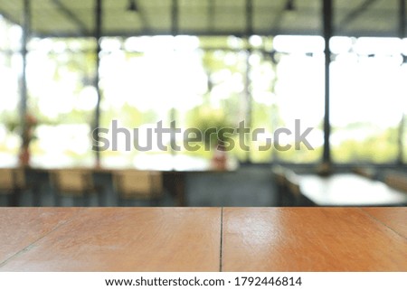 Wooden board empty table in coffee shop for background