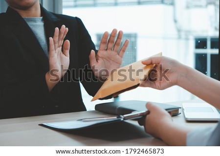 The concept of anti-bribery and corruption. Businessmen refuse and do not receive money banknote offers from businessmen to accept the contract terms of the investment agreement. Royalty-Free Stock Photo #1792465873