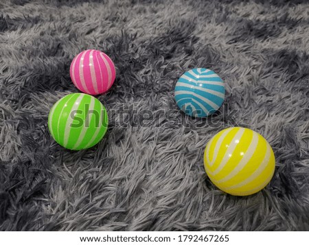 A picture of four balls with fluffy carpet as background. 