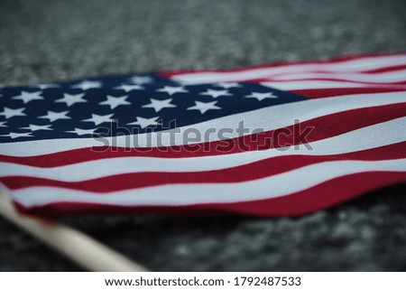 A shallow focus shot of the American flag in a blurred background