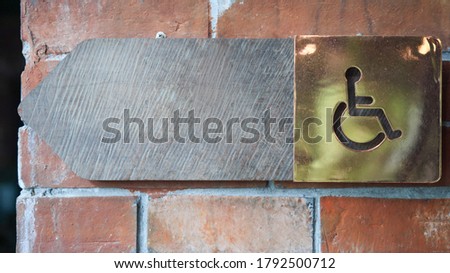 Wooden sign and symbol for the disabled toilet (Ideas for social assistance) there is space left for inserting text for different functions.