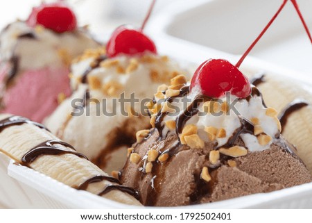 A  closeup selective focus shot of chocolate gelato with chocolate glaze, pistachio, and cherry