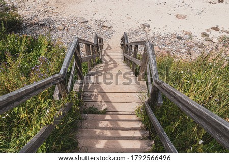 Picturesque wooden stairs leading downwards to a Beach at the Baltic Sea in Germany. Royalty free stock photo.