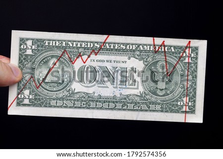 the top and lower limits of the cost in relation to the year, drawn by the cost of the exchange rate on the dollar, a graph drawn by hands on a real dollar bill, close up