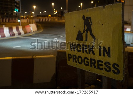 Pictogram vintage under construction street sign in Dubai with context of distracted road at night