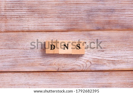 DNS word letters on wooden blocks. Domain Name System. Network, web, communication, technology concept.
