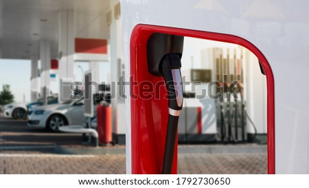 Charging station for electric vehicles in the background of a gas station Royalty-Free Stock Photo #1792730650