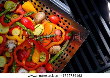 Vegetables in grill basket on outdoor gril