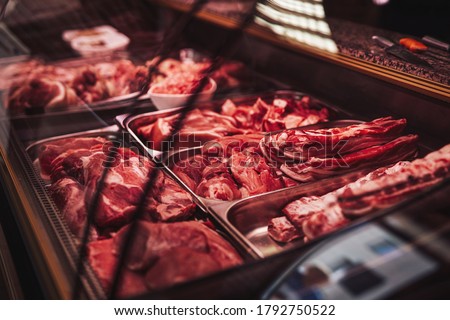 Butcher shop's counter with cold raw meat. Meat business. Selected quality meat selling. Royalty-Free Stock Photo #1792750522