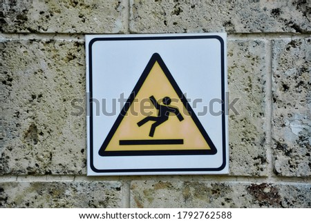 Warning slippery floor sign on the wall