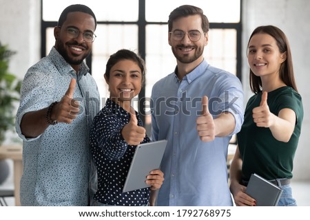 Smiling diverse employees team showing thumbs up, looking at camera, happy overjoyed colleagues recommending best corporate service, good career, human resources and employment concept Royalty-Free Stock Photo #1792768975
