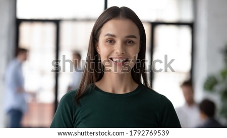 Head shot portrait close up smiling young beautiful businesswoman employee intern looking at camera, successful confident executive ceo manager standing in modern office, posing for photo Royalty-Free Stock Photo #1792769539