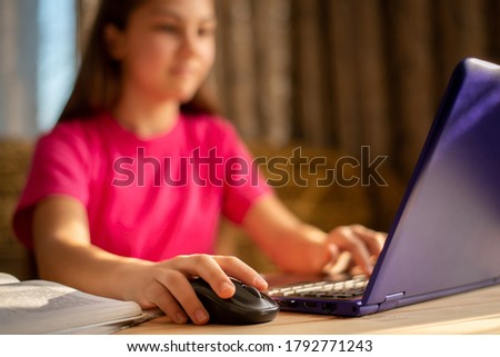 Close-up picture of a hand of a learner girl working on the computer, preparing presentation for geography lesson