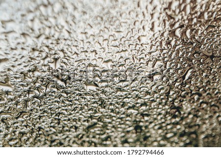 Blurred water droplets on the windscreen. Blurred water droplets on the glass.