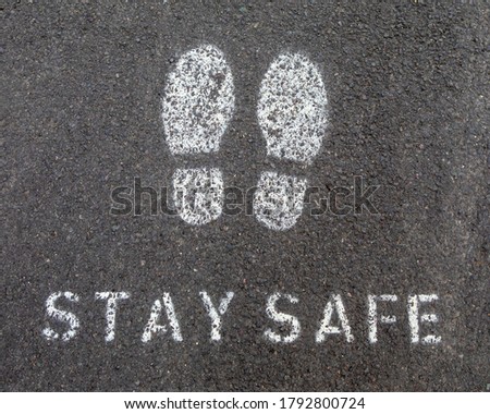 A painted symbol or message on the ground reminding people to Stay Safe - during the Coronavirus pandemic in the UK.